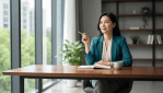 An adult professional preparing for a job interview with a notebook in a bright modern room